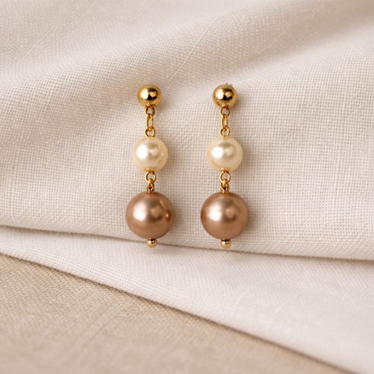 Aretes de perlas en tonos tierra en composición