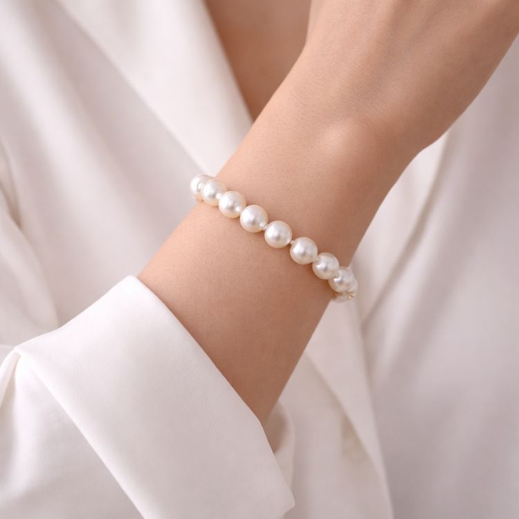 Mujer usando pulsera de perla blanca clásica