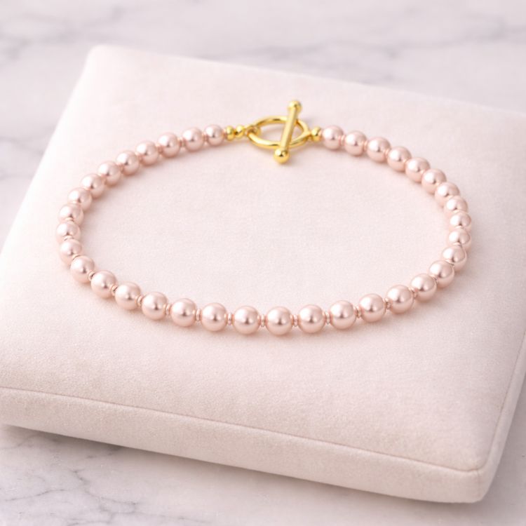 Pulsera de perla rosa pastel 6 mm en exhibidor